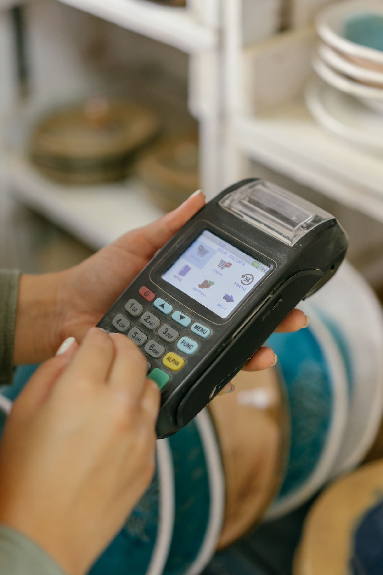 Hand holding a card payment terminal